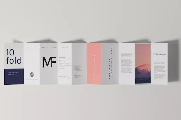 Printed folded leaflets and saddle stitched booklets displayed side by side on a wooden surface